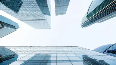 Glass office towers photographed from street level looking up